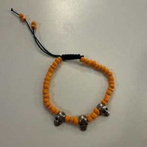 Orange Beaded Bracelet with Silver Skull Charms